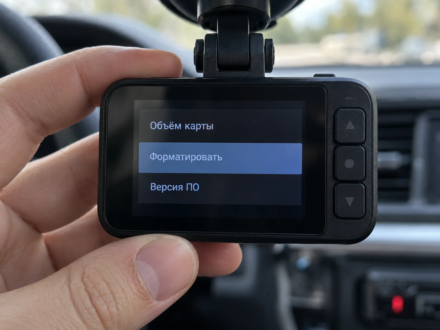 Экран автомобильного видеорегистратора крупным планом, в меню настроек выделен пункт «Форматировать», рядом пункты «Объём карты» и «Версия ПО».